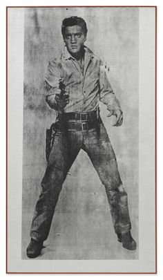 an old black and white photo of a man in cowboy attire with his hands on his hips