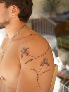 a man with a flower tattoo on his chest
