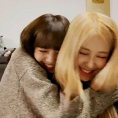 two young women hugging each other with the caption in arabic on top of them