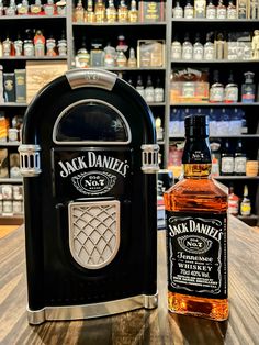 a bottle of jack daniels whiskey sitting next to a toaster on a wooden table