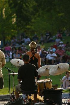 a group of people that are standing in front of some drums