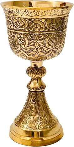 an ornately decorated gold goblet on a white background