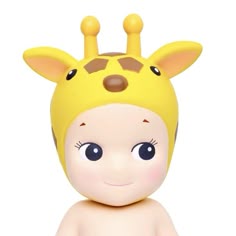 a small toy giraffe with big eyes and a yellow hat on it's head