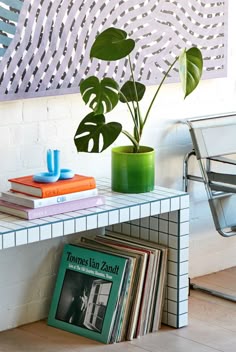 a table with books and a plant on it