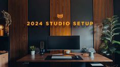a desk with a computer on it in front of a wall that says,'202 studio setup '