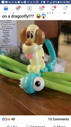 an inflatable balloon dog is sitting on top of some green and blue balloons