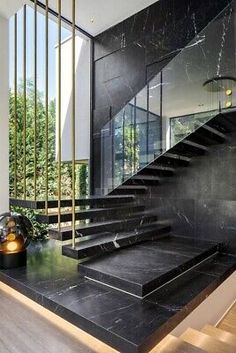 a black marble stair case in front of a staircase