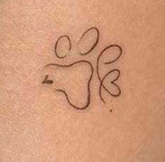 a small tattoo on the back of a woman's arm with an animal symbol