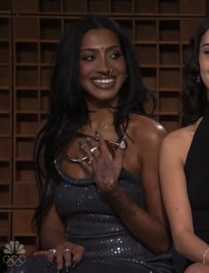 two beautiful women sitting next to each other