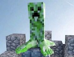 an animated image of a green monster standing on top of some blocks with his arms stretched out