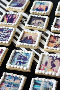 some cookies with pictures on them sitting on a black and white striped tablecloths