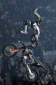 a person on a motorcycle doing a trick in the air