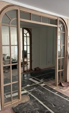 an empty room with large doors and windows