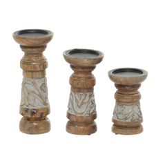three wooden candlesticks sitting next to each other