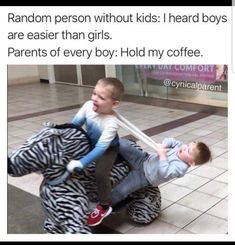a man holding a child on his back while sitting on top of a zebra print chair