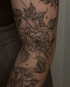 a woman's arm with flowers on it