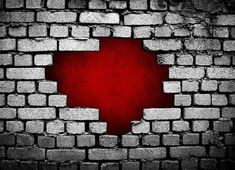 a brick wall with a hole in the middle that has been painted red and white