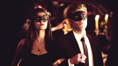 a man and woman dressed up in masquerades