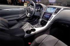 the interior of a car with black leather seats and steering wheel, center console and dashboard