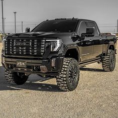 a large black truck parked in a parking lot