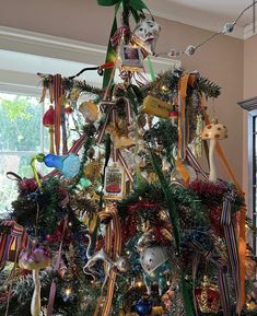 a christmas tree decorated with ribbons and ornaments