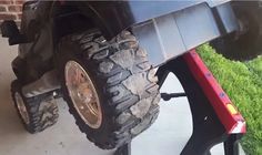 the rear end of a truck with two tires on it's wheels and one tire mounted