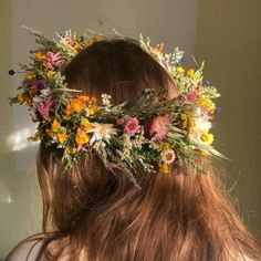a woman with long hair wearing a flower crown