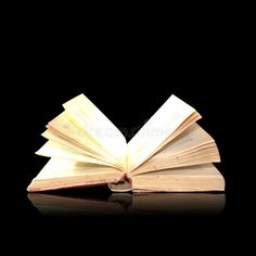 an open book on a black background with reflection royalty images and clippings stock photos