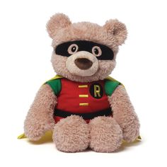a brown teddy bear wearing a red shirt and green cape with the letter r on it's chest