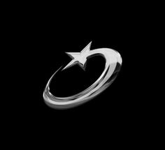 a silver ring with a star on the middle and an arrow in the middle, against a black background