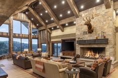 a living room with couches, chairs and a fire place in the middle of it