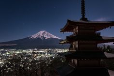 a night view of a city with a mountain in the background