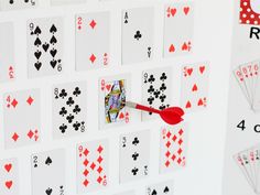 an image of playing cards with a red arrow stuck in them on a white board
