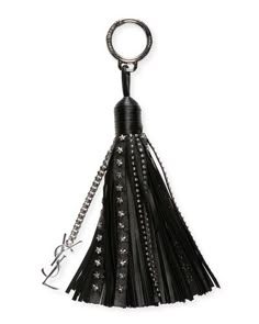a black tasseled keychain hanging from a metal hook