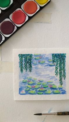 watercolors and paint sitting on top of a table