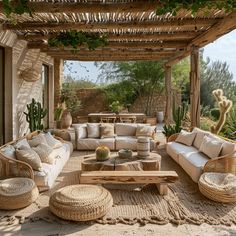 an outdoor living area with wicker furniture and plants