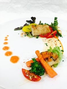 a white plate topped with lots of different types of food on top of each other