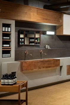 a modern bathroom with two sinks and wooden cabinetry in the back wall, along with shelves on both sides