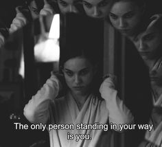 a woman standing in front of a mirror with her hands on her head and the words, the only person standing in your way is you