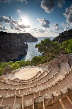 an aerial view of some steps leading to the water and cliffs in front of them