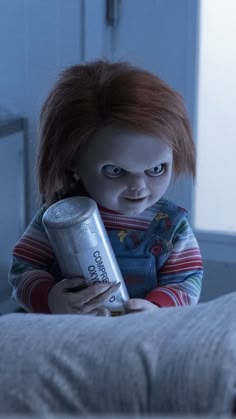 a creepy doll holding a can in her hands