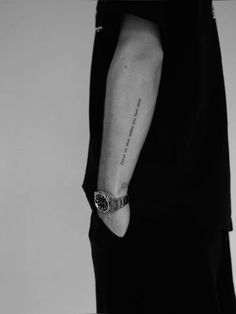 a person with a wrist tattoo on their left arm