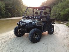 a four - wheeled vehicle is parked on the beach