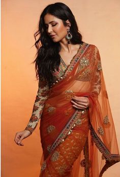 Bollywood Style Orange Embroidered Saree, Orange Bollywood Blouse Piece For Wedding, Orange Bollywood Blouse Piece For Party, Orange Bollywood Style Blouse Piece For Wedding, Bollywood Style Orange Saree With Dupatta, Bollywood Style Orange Blouse Piece For Wedding, Bollywood Style Orange Blouse With Zari Work, Bollywood Style Long Sleeve Blouse With Intricate Embroidery, Bollywood Style Orange Blouse Piece