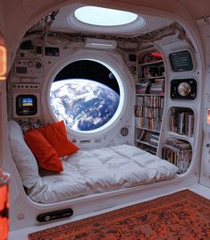 an astronaut's bedroom with a view of the earth through its window and bookshelves