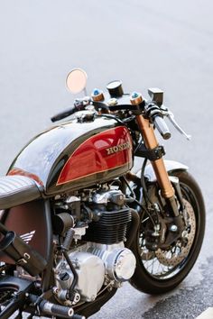 a red and black motorcycle parked on the street