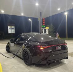 an electric car plugged up at a gas station