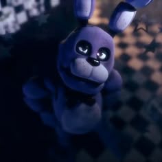 a purple rabbit is standing in front of a checkered wall and looking up at the camera