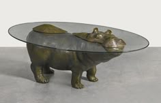 a glass and metal table with a rhinoceros design on it