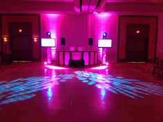 the dance floor is lit up with bright lights and sound speakers on each side of it